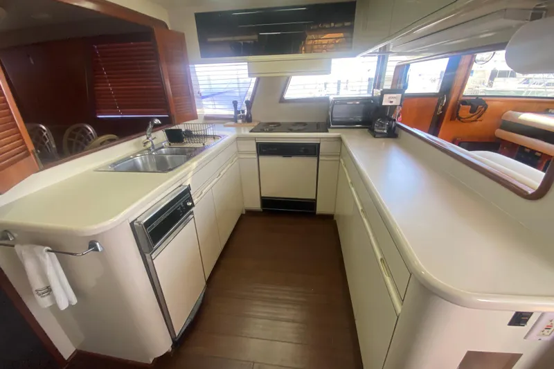 Sea Sharp Yacht Photos Pics Spacious kitchen in 1990 Viking 63 Motor Yacht with modern appliances and ample counter space.