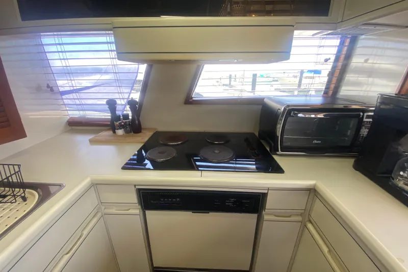 Sea Sharp Yacht Photos Pics 1990 Viking 63 Motor Yacht kitchen with stove, oven, and countertop appliances.