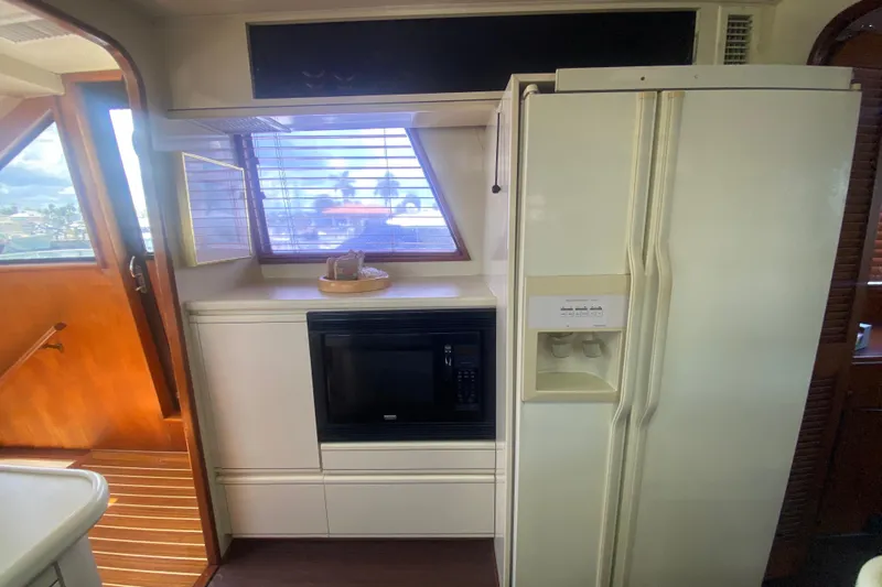 Sea Sharp Yacht Photos Pics Interior of 1990 Viking 63 Motor Yacht kitchen with fridge and microwave.