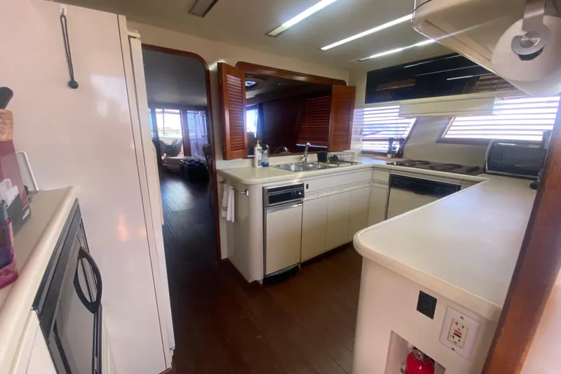 Sea Sharp Yacht Photos Pics Interior kitchen of a 1990 Viking 63 Motor Yacht with modern appliances.