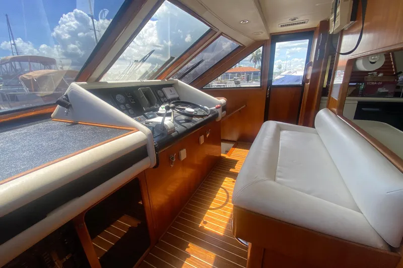 Sea Sharp Yacht Photos Pics Interior of 1990 Viking 63 Motor Yacht with helm and seating area.