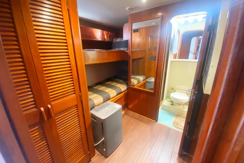Sea Sharp Yacht Photos Pics Interior of 1990 Viking 63 Motor Yacht with bunk beds and bathroom.