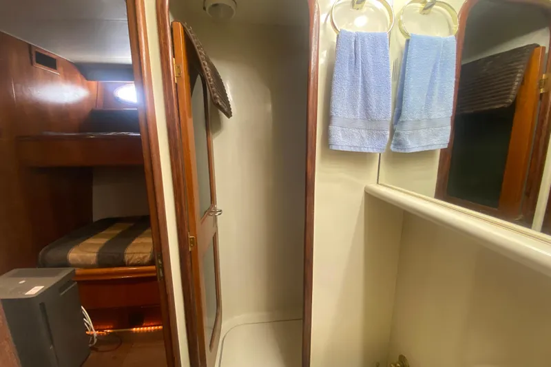 Sea Sharp Yacht Photos Pics Interior of 1990 Viking 63 Motor Yacht with bunk beds and bathroom.