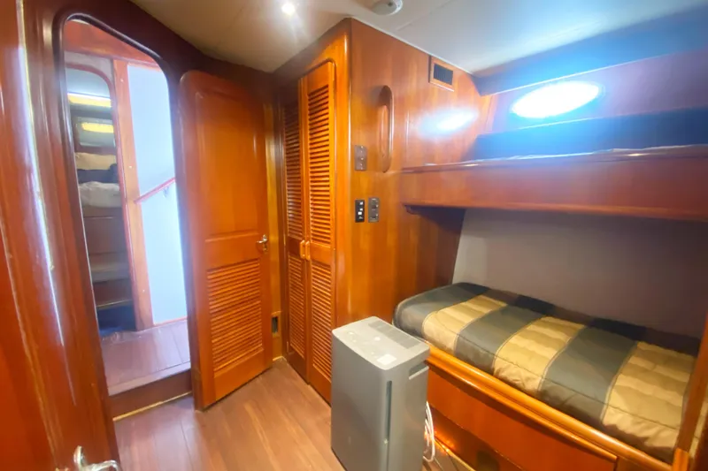 Sea Sharp Yacht Photos Pics Interior of 1990 Viking 63 Motor Yacht with wooden bunk beds and storage.