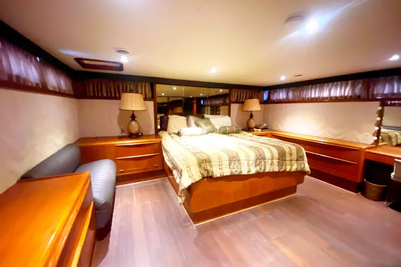 Sea Sharp Yacht Photos Pics Luxurious bedroom interior of 1990 Viking 63 Motor Yacht with elegant wood furnishings.