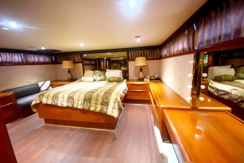 Sea Sharp Yacht Photos Pics Luxurious bedroom interior of a 1990 Viking 63 Motor Yacht with elegant wood furnishings.