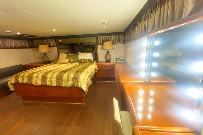 Sea Sharp Yacht Photos Pics Luxurious bedroom interior of 1990 Viking 63 Motor Yacht with elegant wood furnishings.