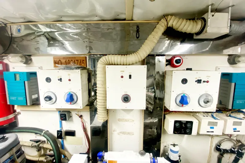 Sea Sharp Yacht Photos Pics Engine room of a 1990 Viking 63 Motor Yacht with control panels and ventilation system.