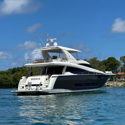 Oceana Yacht Photos Pics Luxury 2015 Prestige 750 yacht on water, featuring sleek design and spacious deck. Repainted Transom to enhance the lines.