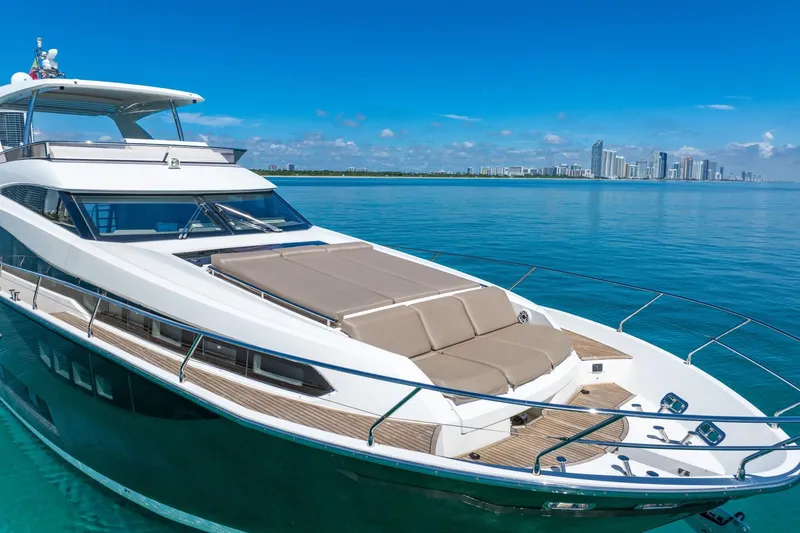 Oceana Yacht Photos Pics Luxurious 2015 Prestige 750 yacht cruising on clear blue waters with city skyline backdrop.