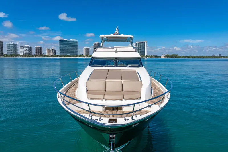Oceana Yacht Photos Pics Luxurious 2015 Prestige 750 yacht on calm waters with city skyline backdrop.