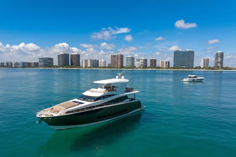 Oceana Yacht Photos Pics Luxury 2015 Prestige 750 yacht on calm waters with city skyline backdrop.