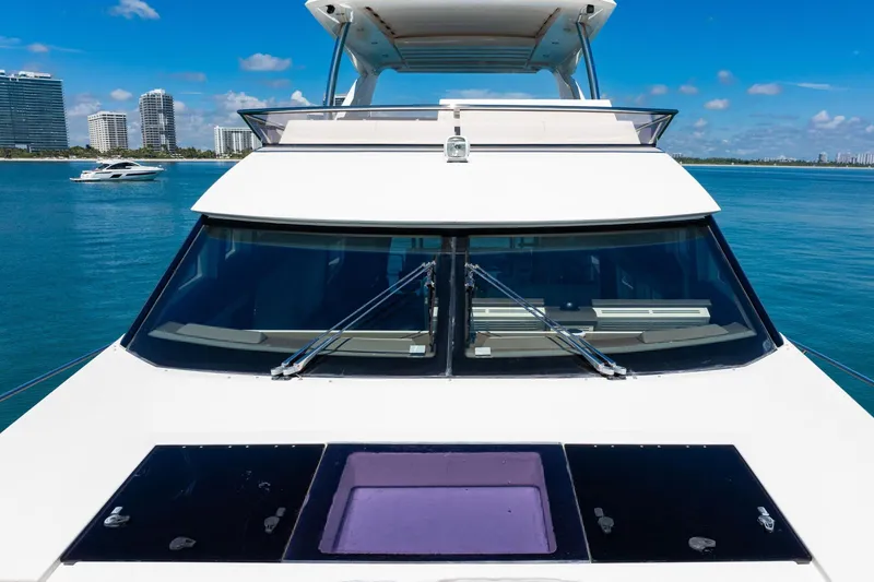 Oceana Yacht Photos Pics Luxury 2015 Prestige 750 yacht on serene blue waters with city skyline.