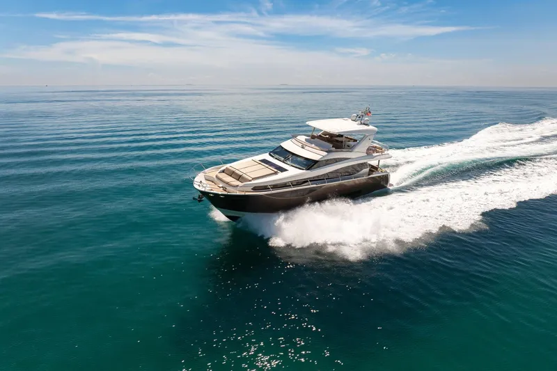 Oceana Yacht Photos Pics Luxurious 2015 Prestige 750 yacht cruising on open sea under clear blue sky.