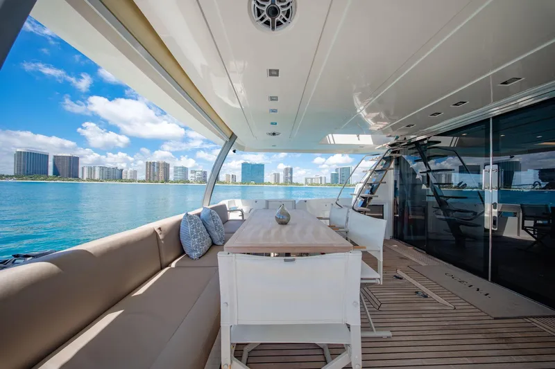 Oceana Yacht Photos Pics Luxurious 2015 Prestige 750 yacht deck with seating, table, and ocean view.