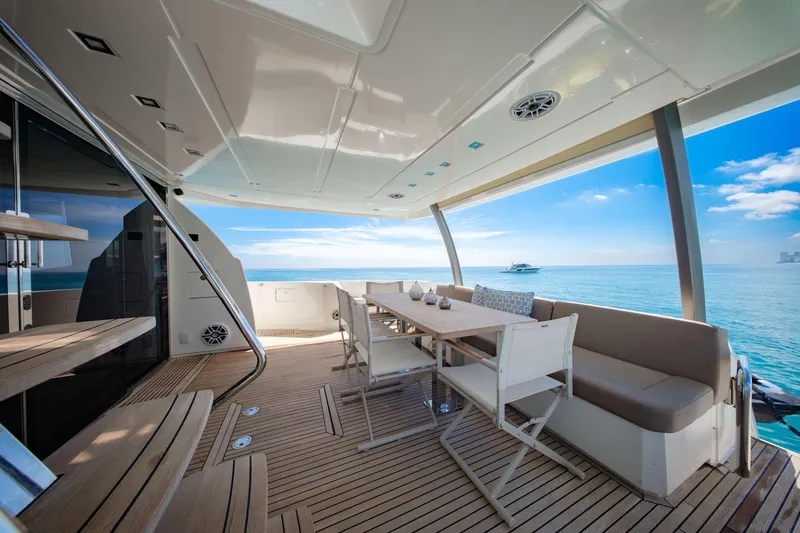 Oceana Yacht Photos Pics Luxurious 2015 Prestige 750 yacht deck with dining area overlooking serene ocean view.