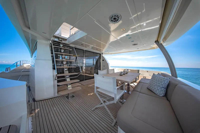 Oceana Yacht Photos Pics Luxurious 2015 Prestige 750 yacht deck with seating, dining area, and ocean view.