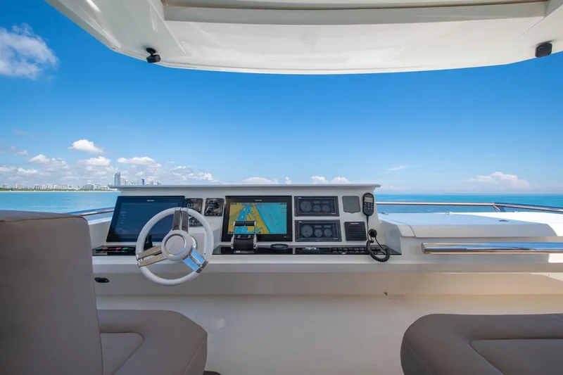 Oceana Yacht Photos Pics Helm of 2015 Prestige 750 yacht with navigation screens, steering wheel, and ocean view.
