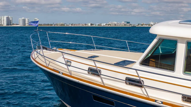 Pinch Me Yacht Photos Pics 2015 Sabre 48 Salon Express yacht on blue ocean with city skyline in background.