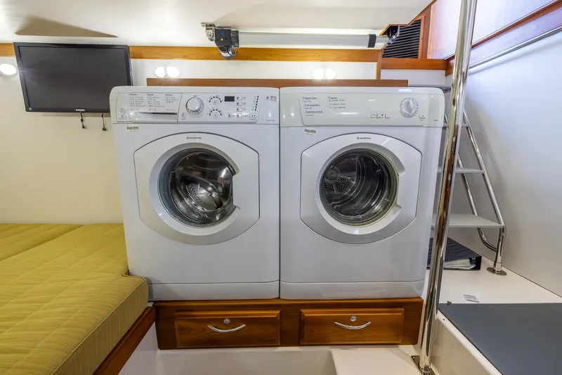 Pinch Me Yacht Photos Pics Laundry area inside 2015 Sabre 48 Salon Express yacht with washer and dryer.
