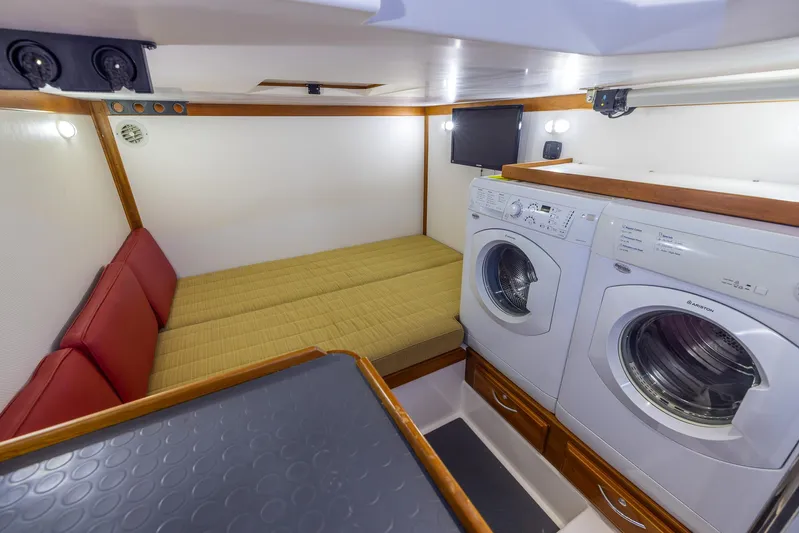 Pinch Me Yacht Photos Pics Laundry area and seating in 2015 Sabre 48 Salon Express yacht interior.