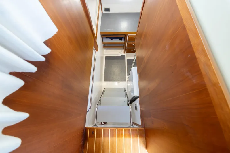 Pinch Me Yacht Photos Pics Interior view of 2015 Sabre 48 Salon Express, featuring wooden cabinetry and modern design.