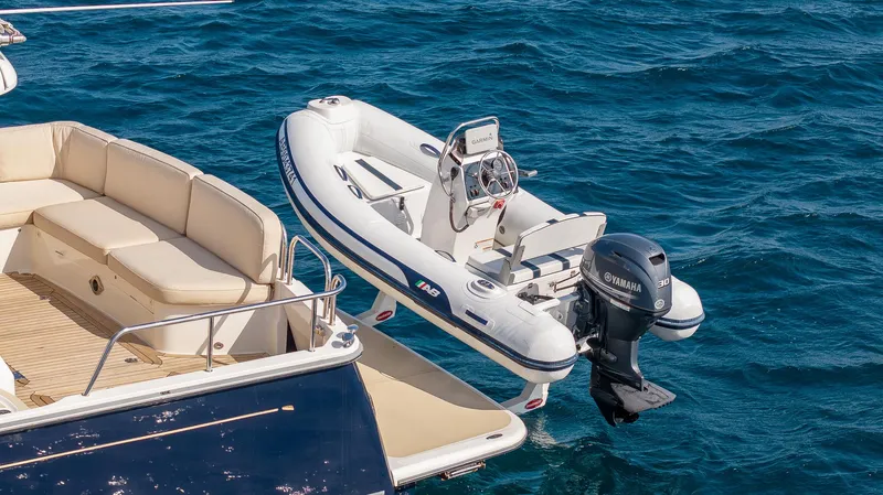 Pinch Me Yacht Photos Pics 2015 Sabre 48 Salon Express with tender boat on blue ocean water.