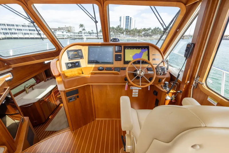 Pinch Me Yacht Photos Pics 2015 Sabre 48 Salon Express helm with navigation screens and wooden steering wheel.
