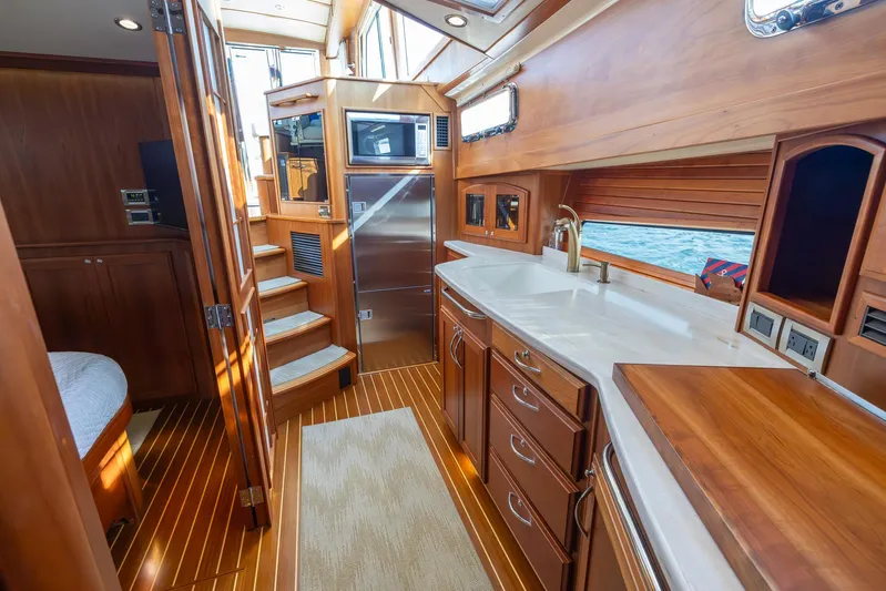 Pinch Me Yacht Photos Pics Luxurious interior of 2015 Sabre 48 Salon Express yacht with wooden cabinetry and modern amenities.