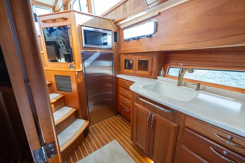 Pinch Me Yacht Photos Pics Luxurious interior of 2015 Sabre 48 Salon Express yacht with wooden cabinetry and modern amenities.
