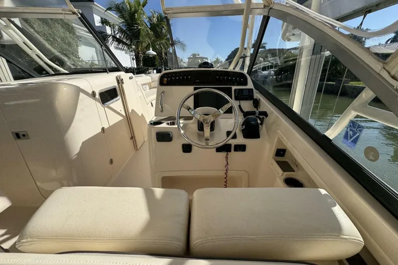  Yacht Photos Pics 2016 Grady-White Freedom 307 boat interior with steering wheel and seating.