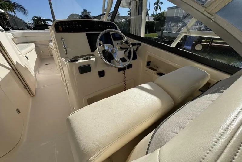  Yacht Photos Pics 2016 Grady-White Freedom 307 boat interior with steering wheel and seating.