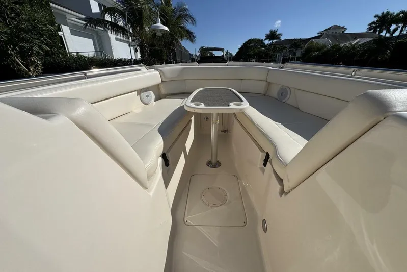  Yacht Photos Pics 2016 Grady-White Freedom 307 boat interior with cushioned seating and table.