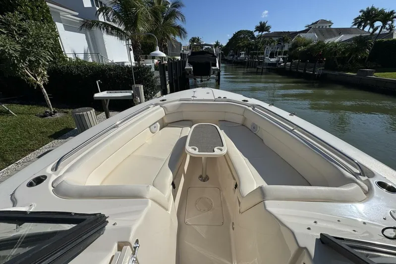  Yacht Photos Pics 2016 Grady-White Freedom 307 boat with spacious seating, docked in a scenic canal.