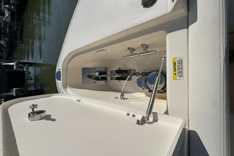  Yacht Photos Pics 2016 Grady-White Freedom 307 boat anchor compartment with caution label and hydraulic support.