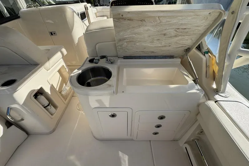  Yacht Photos Pics 2016 Grady-White Freedom 307 boat interior with sink and storage compartments.