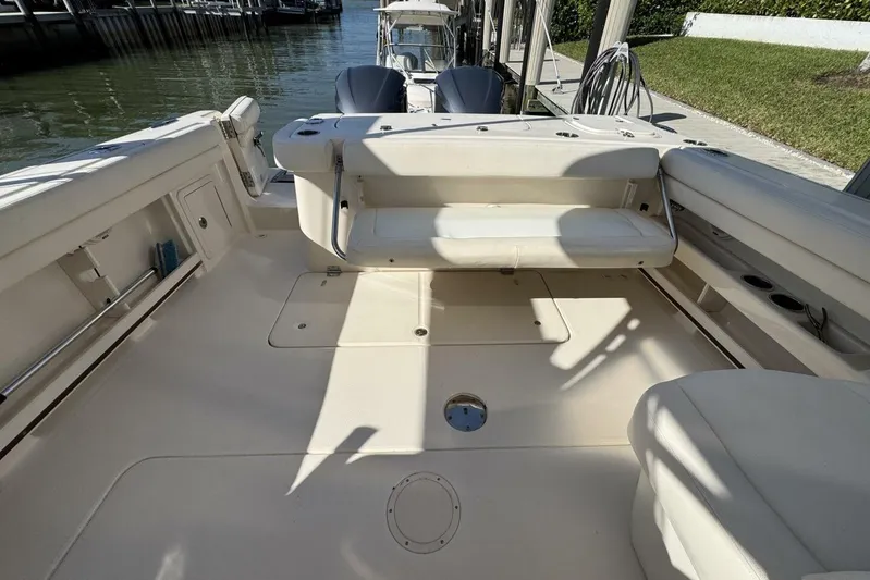  Yacht Photos Pics 2016 Grady-White Freedom 307 boat interior with seating and storage, docked by the water.