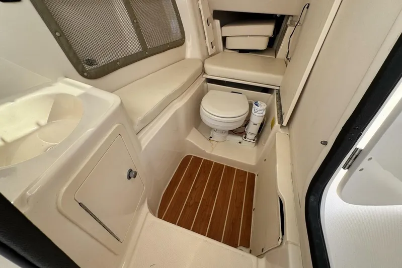  Yacht Photos Pics 2016 Grady-White Freedom 307 boat interior with toilet and seating area.