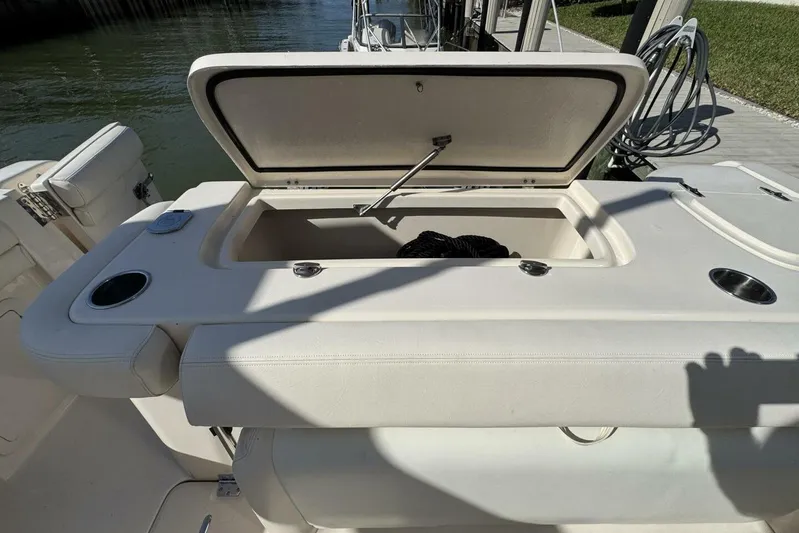  Yacht Photos Pics 2016 Grady-White Freedom 307 boat with open storage compartment, dockside view.