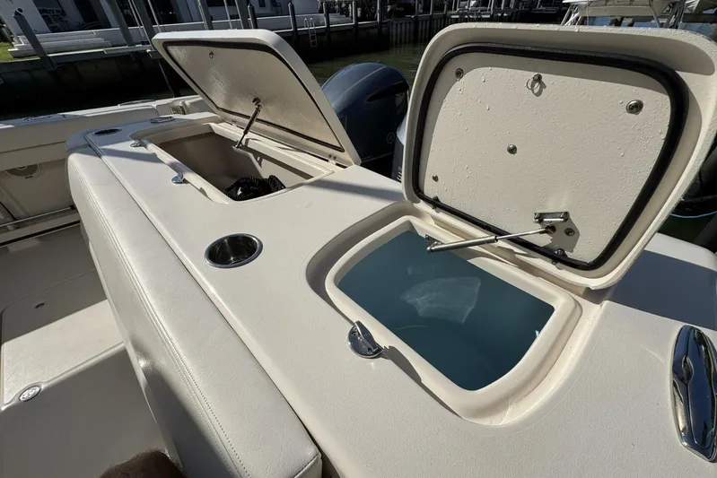  Yacht Photos Pics 2016 Grady-White Freedom 307 boat with open storage compartments and cup holder.