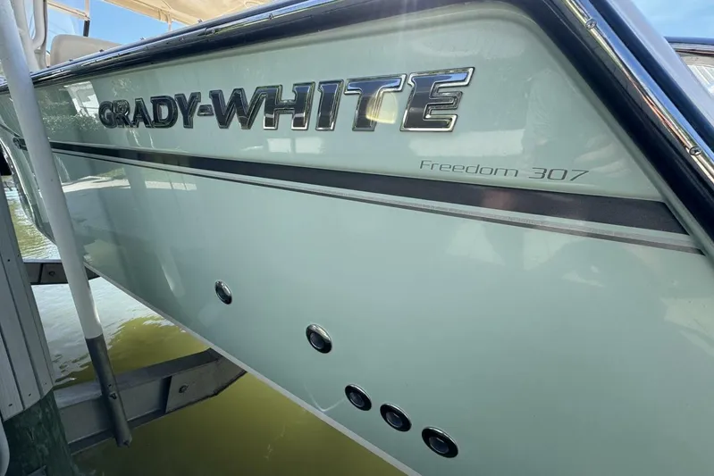  Yacht Photos Pics 2016 Grady-White Freedom 307 boat side view with logo and model name.