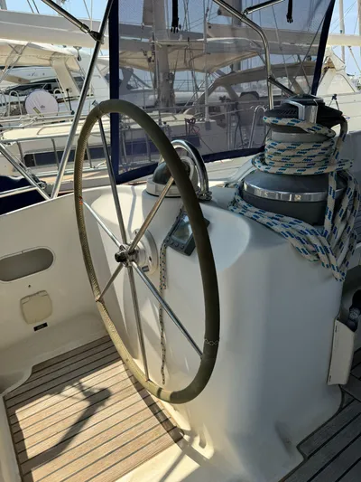  Yacht Photos Pics Steering wheel of a 2004 Beneteau 50 sailboat with winch and ropes.
