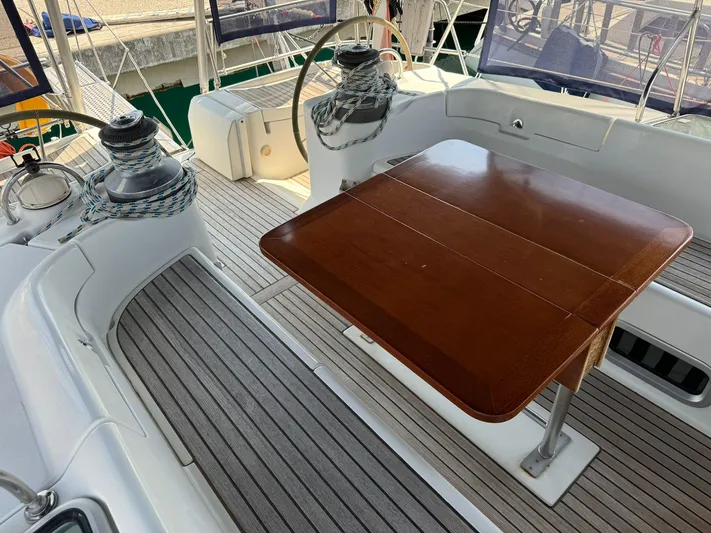  Yacht Photos Pics Cockpit of 2004 Beneteau 50 sailboat with wooden table and dual steering wheels.