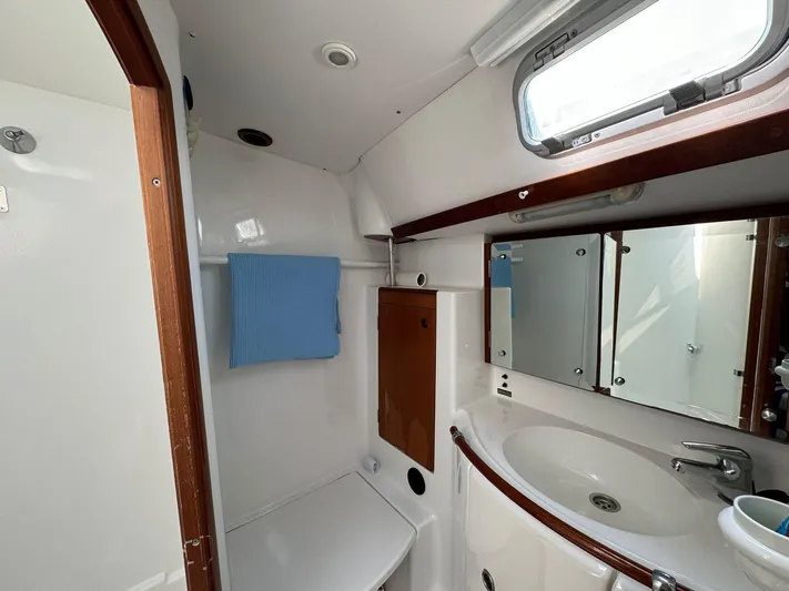  Yacht Photos Pics 2004 Beneteau 50 yacht bathroom with sink, mirror, and towel.