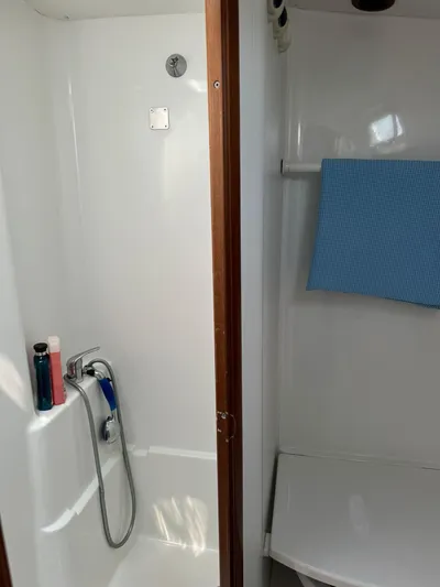  Yacht Photos Pics Shower area in 2004 Beneteau 50 yacht, featuring modern fixtures and a blue towel.