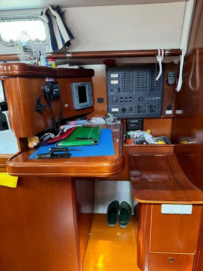  Yacht Photos Pics Navigation station inside 2004 Beneteau 50 yacht with control panel and wooden cabinetry.