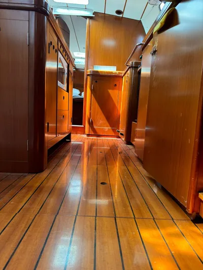  Yacht Photos Pics Interior view of 2004 Beneteau 50 yacht with polished wooden flooring and cabinetry.