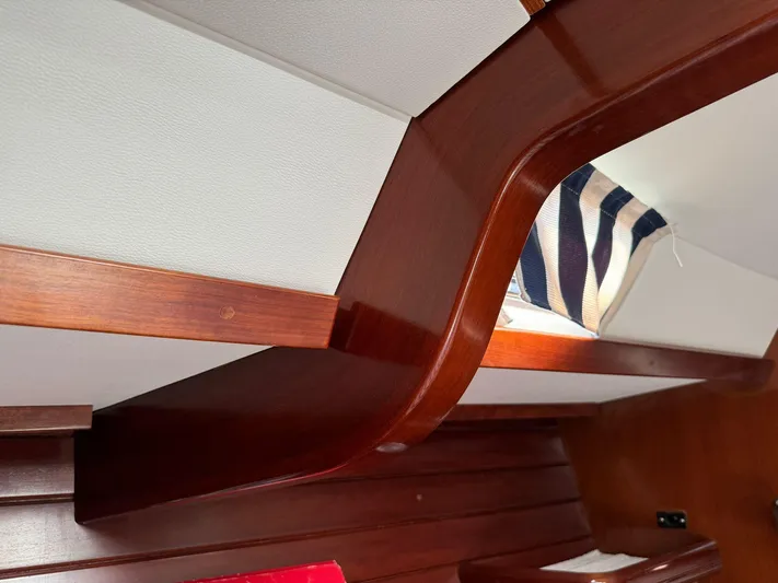  Yacht Photos Pics Interior of 2004 Beneteau 50 yacht with wooden cabinetry and striped fabric detail.
