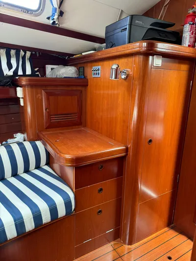  Yacht Photos Pics Interior of 2004 Beneteau 50 yacht with wooden cabinetry and striped seating.