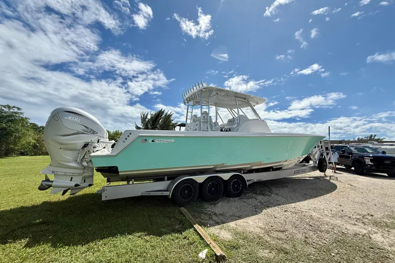  Yacht Photos Pics 2023 Contender 39 Fisharound boat on trailer, featuring Yamaha engines, under a clear blue sky.